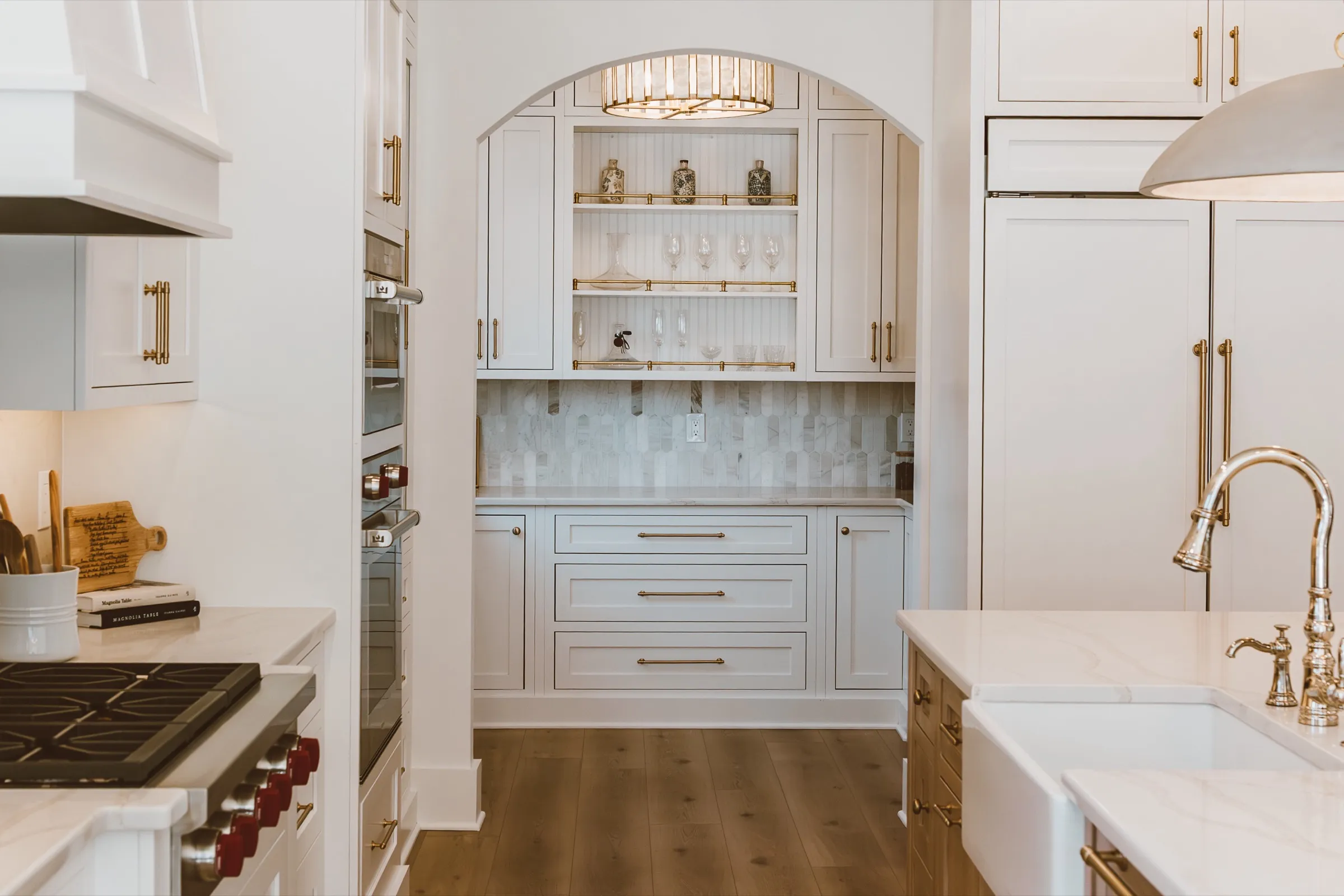 Kitchen opening to an arched butler’s pantry