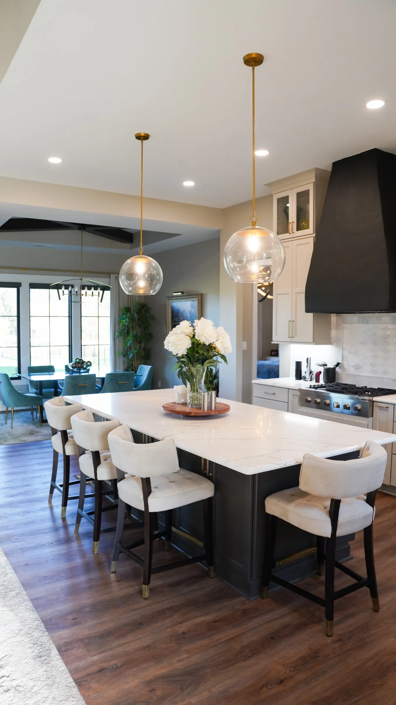 Kitchen island with seating and a black range hood