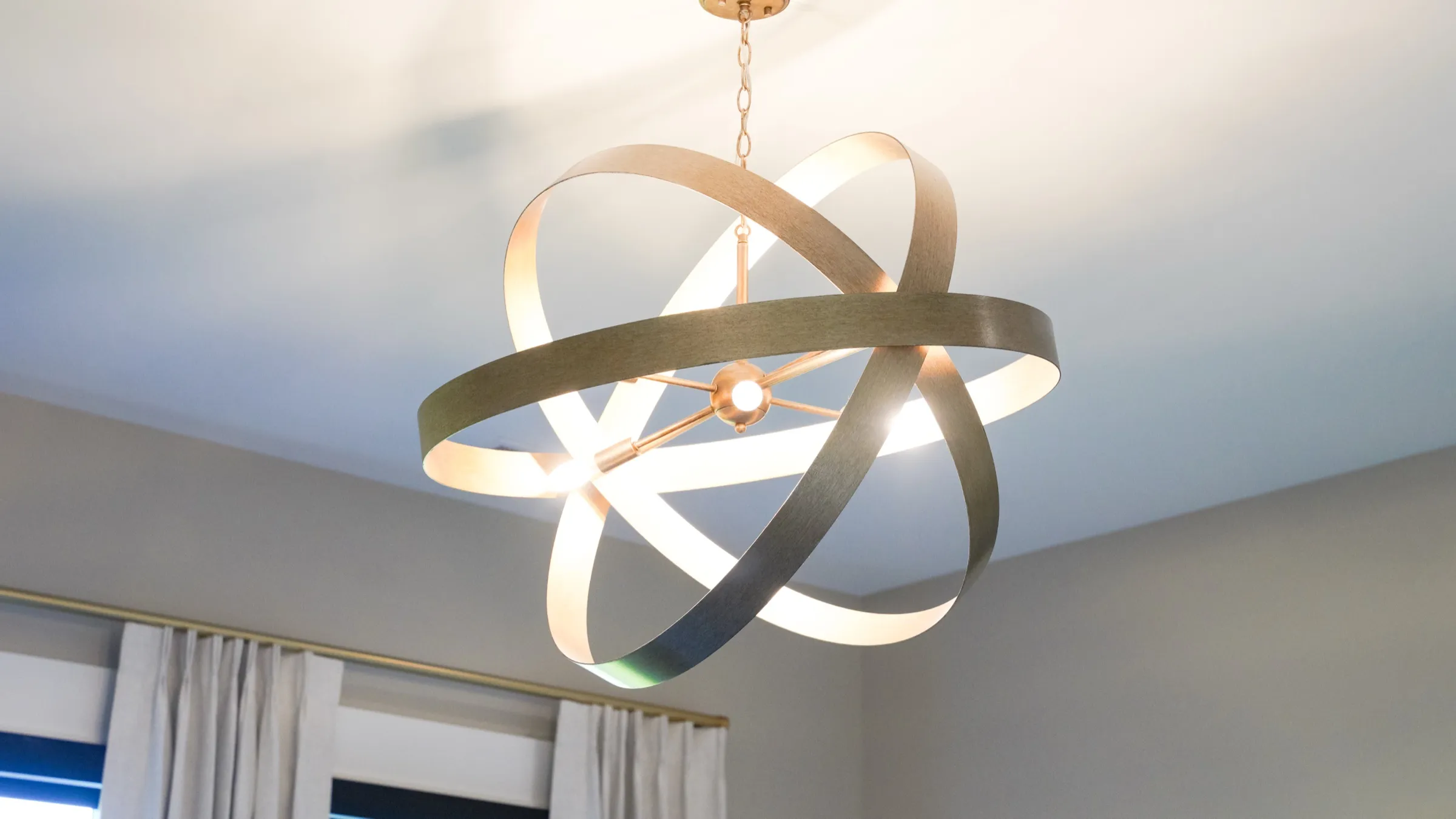 Sculptural chandelier against a vaulted ceiling