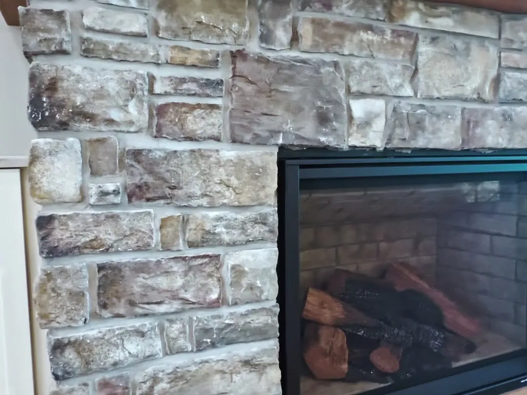 Stone fireplace with a reclaimed timber mantel
